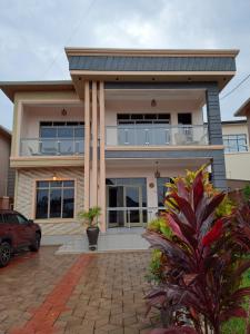 a large house with a balcony on top of it at Wepick Homes in Kigali