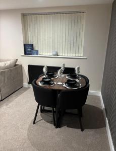 a small table in a living room with a couch and a table at Tarn House Apartment South Yorksire in Barnsley +1 photo