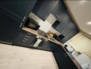 an overhead view of a kitchen with black cabinets at Tarn House Apartment South Yorksire in Barnsley