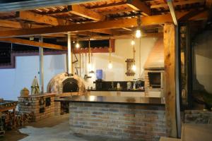 a kitchen with a brick counter and an oven at Quinta Nallig in Gualaceo