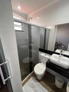 a bathroom with a toilet and a sink at Motel Segredos (Adults Only) in Guarulhos +8 photos