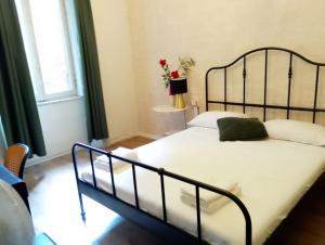 a bedroom with a bed with a black metal frame at Hotel ambra milano in Milan