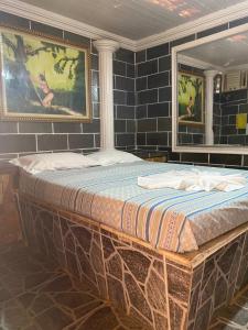 a large bed in a room with blue tiles at Residencial Silvas AP 02 in Macapá