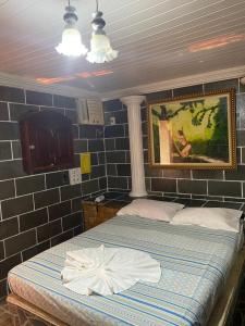 a bedroom with a bed and a painting on the wall at Residencial Silvas AP 02 in Macapá