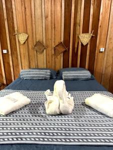 two twin beds in a room with wooden walls at Hotel Arara Azul in Manaus +34 photos