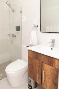 un bagno con un water, un lavandino e uno specchio di La Isla Royal - Materia Oscura a Miches