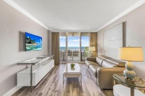 a living room with a couch and a table at Marco Beach Ocean Resort 910 in Marco Island