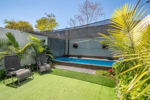 a backyard with a swimming pool and some plants at Private Pool & Jacuzzi Family House, Teques in Tlatenchu
