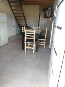 a kitchen and dining room with a table and chairs at JAS departamento in General Acha +4 photos