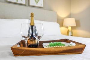 a tray with a bottle of champagne and two glasses at Marco Beach Ocean Resort 910 in Marco Island