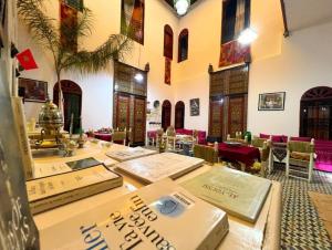 a room with a table with boxes on it at Riad Iman in Fès
