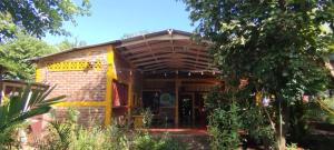 a small brick house with a wooden roof at El Güis hostel in Balgue