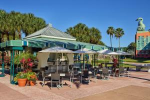 a restaurant with tables and chairs and umbrellas at Walt Disney World Swan in Orlando