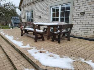 A&G SoDYBA LIUXAPARTAMENT في بلونج: طاولة ومقاعد مغطاة بالثلوج في الفناء +4 صور