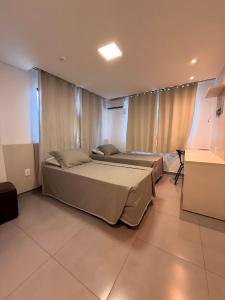 Ένα ή περισσότερα κρεβάτια σε δωμάτιο στο Hotel Mais Lazer