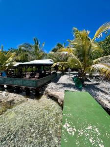 a resort with a green lawn on the beach at Motu Tahuhu Lodge in Rangiroa +29 photos