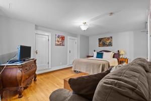 Modern Manor Studio WiFi Parking في سانت جون: غرفة معيشة بها أريكة وسرير