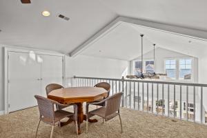 a dining room with a table and chairs at Penthouse in Atlantic Beach