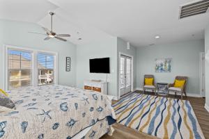a bedroom with a bed and a flat screen tv at Penthouse in Atlantic Beach
