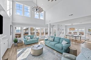 a living room with two blue couches and a table at Penthouse in Atlantic Beach