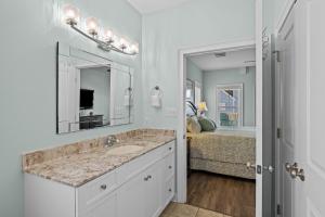 a bathroom with a sink and a mirror and a bed at Penthouse in Atlantic Beach +35 photos