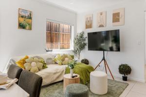 a living room with a couch with stuffed animals on it at Comfy Home in Deebing Heights in Loamside