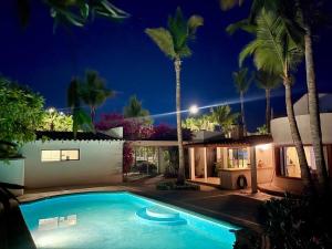 a swimming pool in front of a house at night at Garden and Pool Casita in La Paz