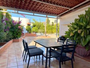 a table and chairs on a patio with plants at Garden and Pool Casita in La Paz