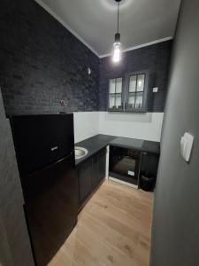 a bathroom with a black counter and a sink at Eleon in Novi Sad