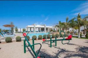 Los BledalesWater House的泳池前的一组健身器材