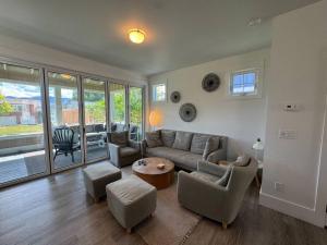 a living room with a couch and chairs and a table at Honeysuckle Beach Oasis at Veranda Beach in Oroville