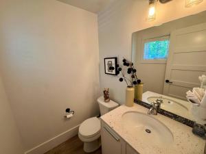 a white bathroom with a sink and a toilet at Honeysuckle Beach Oasis at Veranda Beach in Oroville +8 photos
