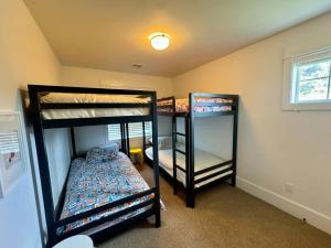 two bunk beds in a room with a window at Honeysuckle Beach Oasis at Veranda Beach in Oroville
