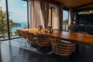 a wooden table and chairs with a view of the ocean at Barad Lux Villa in Mae Haad