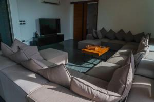 a living room with a couch and a table at Barad Lux Villa in Mae Haad