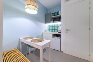 a kitchen with a white table and two stools at Villa Emma Exclusive in the Historic Center-Sorrento Coast in Vico Equense