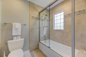 a bathroom with a toilet and a glass shower at The Landing at Wheat St. 2Br in Columbia +17 photos