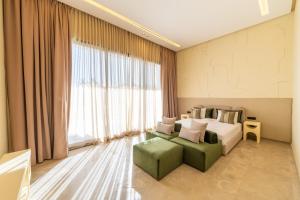 a bedroom with a bed and a couch and a window at Berber Garden in Aït Amara +44 photos