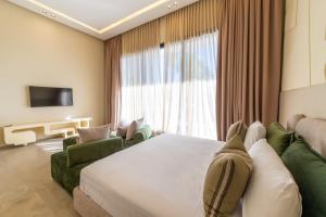 a hotel room with a bed and a large window at Berber Garden in Aït Amara