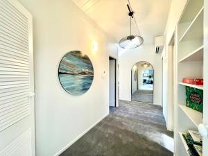 a hallway of a house with a round window on the wall at Iconic Taupō Views in Taupo