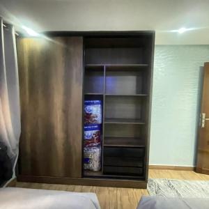 a room with a book shelf with snacks on it at Prime stay downtown Meknes in Meknès