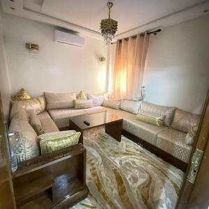 a living room with a couch and a table at Prime stay downtown Meknes in Meknès +15 photos