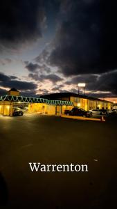 a building in a parking lot with the word warration at Extended Stay Warrenton Inn in Warrenton