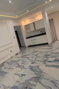 una cucina con pavimento in marmo e armadi bianchi di Eliana Castle a Trofwi Altre 8 foto