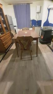 a living room with a wooden table and a chair at Shambhala Holiday House in Blatuša