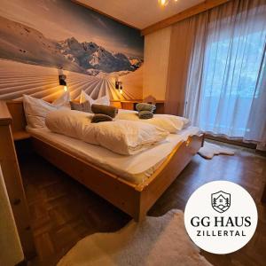 a bedroom with a bed with a mountain mural on the wall at GG Haus Zillertal in Finkenberg