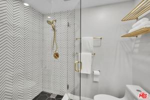 a white bathroom with a shower and a toilet at Echo Lake view condo - newly renovated - centrally located in Los Angeles +24 photos