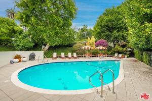 a swimming pool with chairs and umbrellas at Echo Lake view condo - newly renovated - centrally located in Los Angeles