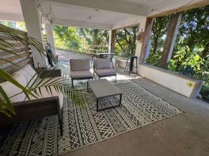 a patio with chairs and a table and a rug at The Spot at Rincon in Rincon