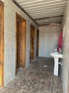 a bathroom with a toilet and a sink at Desert Time in Wadi Rum +62 photos
